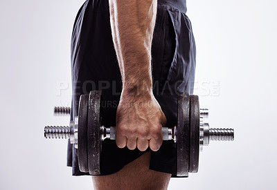 Buy stock photo Closeup, man and hand with dumbbell for exercise with muscle development, workout and wellness in studio. Male bodybuilder, training and holding iron weights for strong arms by white background