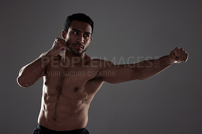 Buy stock photo Man, boxer and punching in studio for fitness for mma sport, fighter and background or training for challenge or competition fight. Strong, power and exercise for strength, combat workout and health