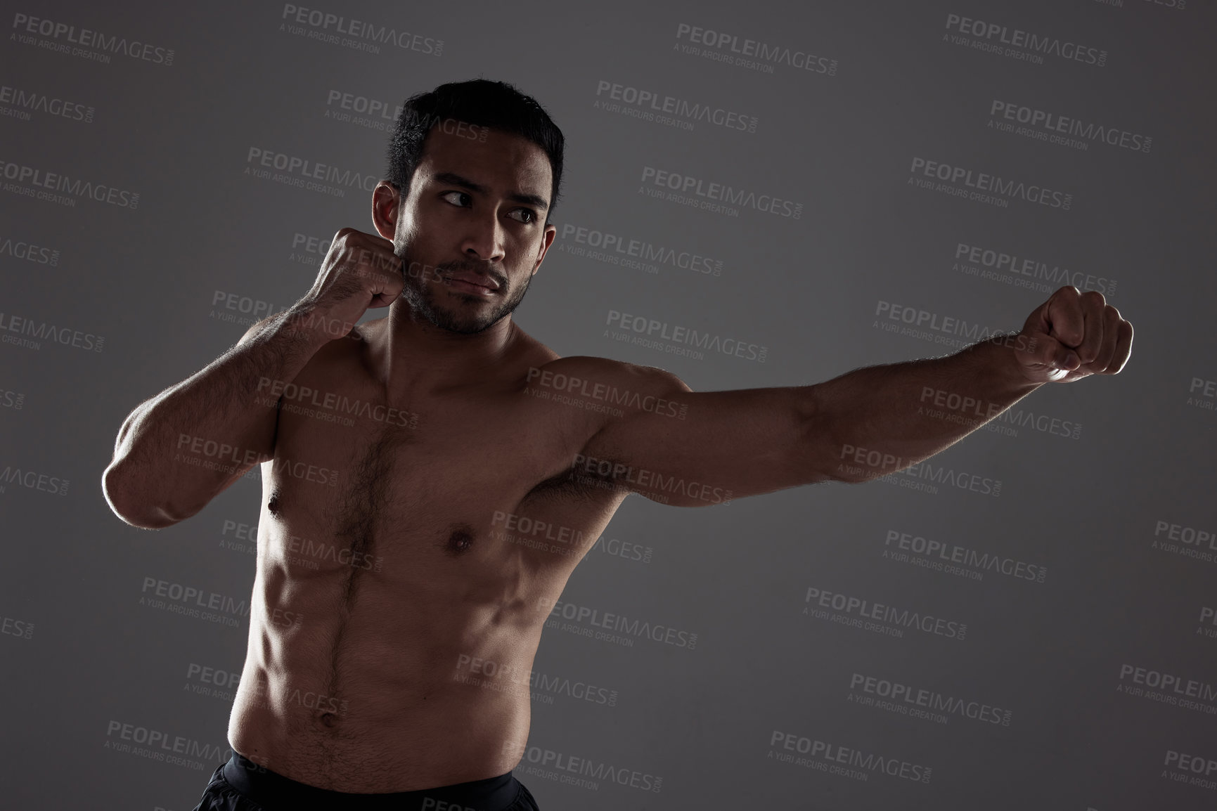 Buy stock photo Man, boxer and punching in studio for fitness for mma sport, fighter and background or training for challenge or competition fight. Strong, power and exercise for strength, combat workout and health