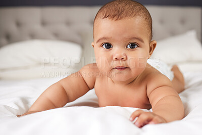 Buy stock photo Shot of an adorable baby boy on the bed at home