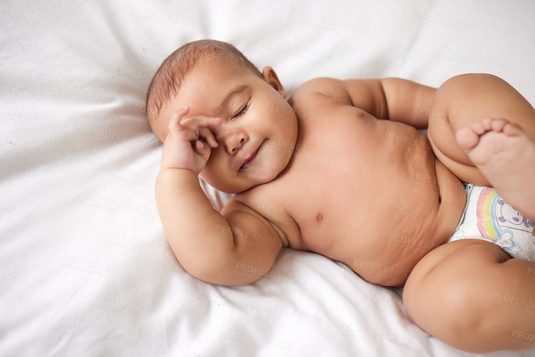 Buy stock photo Shot of an adorable baby boy on the bed at home