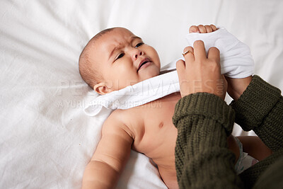 Buy stock photo Bed, mother and dress crying baby in nursery with morning routine, changing clothes and child care. Woman, hands and getting ready with grumpy infant in bedroom for hygiene, impatient and top view