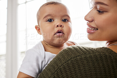 Buy stock photo Shot of a young mother holding her baby