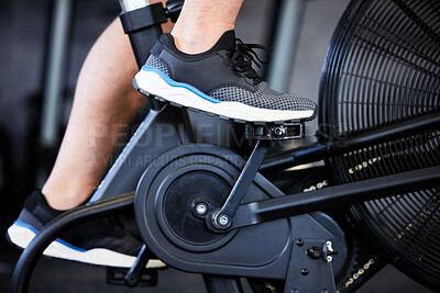 Buy stock photo Feet, fitness and a man on a gym bicycle for cardio, cycling and exercise. Legs, shoes and a person on a bike for sports, health and training with a workout on a machine for physical activity