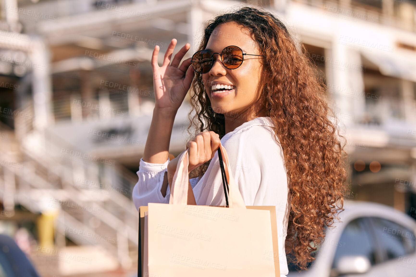 Buy stock photo Woman, sunglasses and shopping bag in city for sale discount or fashion retail, product or promotion. Female person, travel and happy in California with buying purchase for gift deal, urban or street