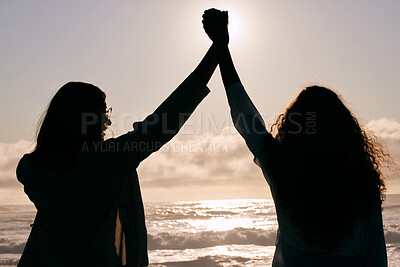 Buy stock photo Ocean, silhouette and people holding hands with freedom, friendship and bonding for success, solidarity and support. Back view, travel and celebrate together outdoor with holiday, adventure and team