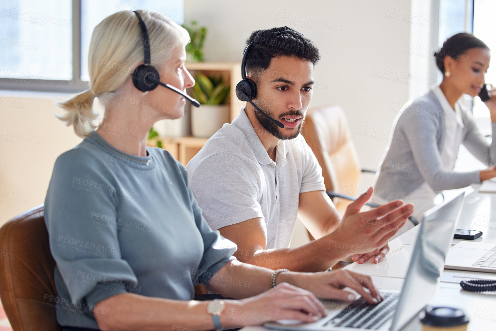 Buy stock photo Crm, people and conversation in office with headphones, virtual assistant and inbound telemarketing for support. Female advisor, male agent and talking together in call center for customer service.