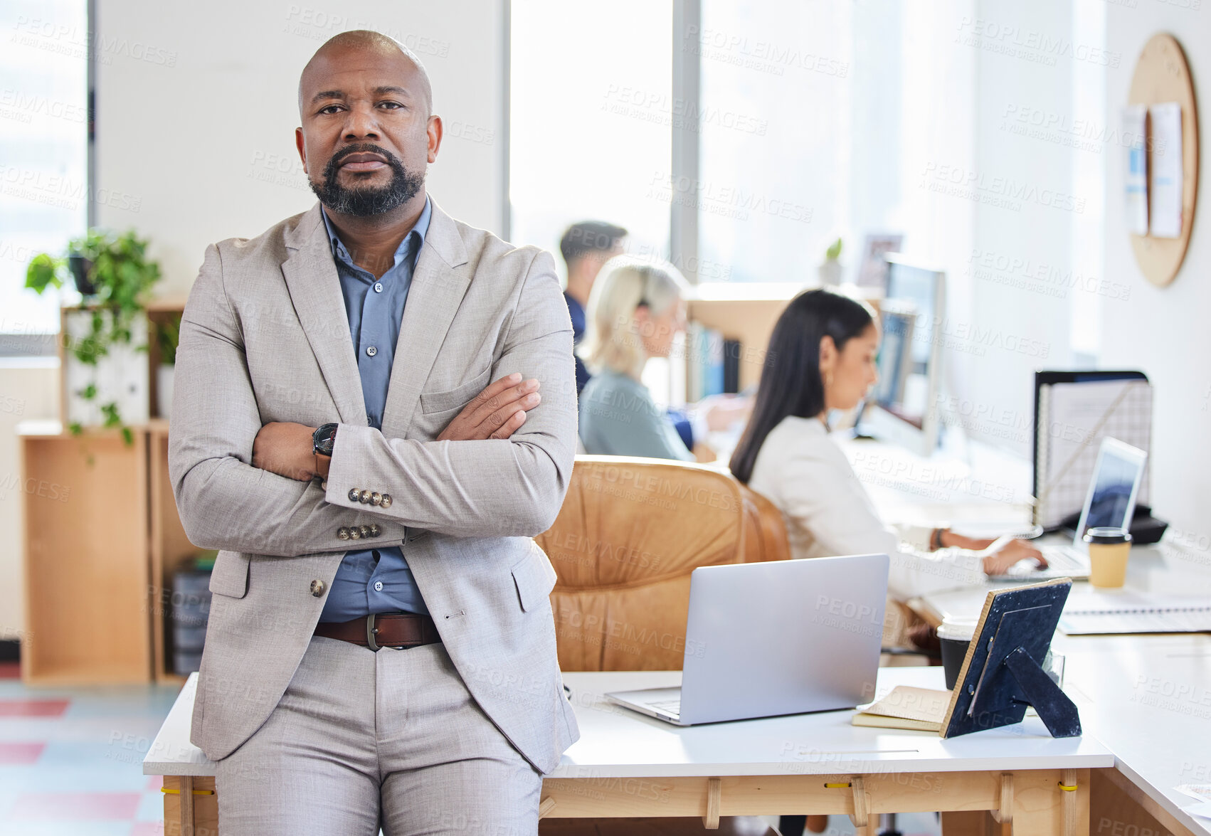 Buy stock photo Portrait of a mature businessman standing with his arms crossed in a call centre