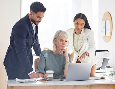 Buy stock photo Shot of a group of businesspeople working together on a laptop in an office