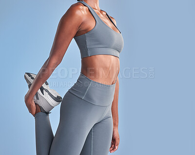 Buy stock photo Studio shot of a fit woman stretching against a grey background