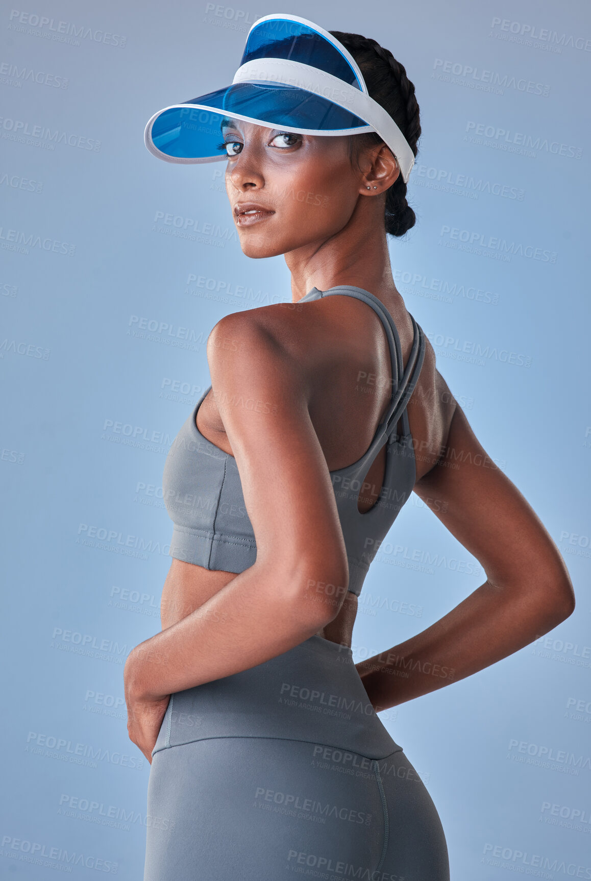 Buy stock photo Studio shot of a fit young woman posing against a grey background