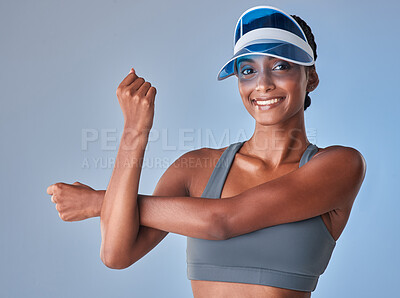 Buy stock photo Studio shot of a fit young woman stretching against a grey background