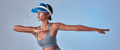 Buy stock photo Studio shot of a fit young woman stretching against a grey background