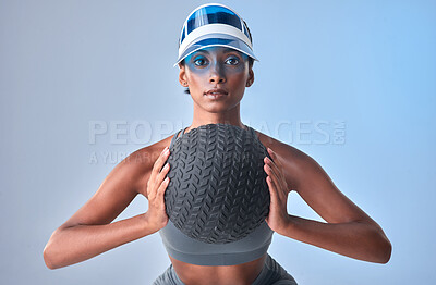 Buy stock photo Studio shot of a fit young woman working out with a medicine ball against a grey background