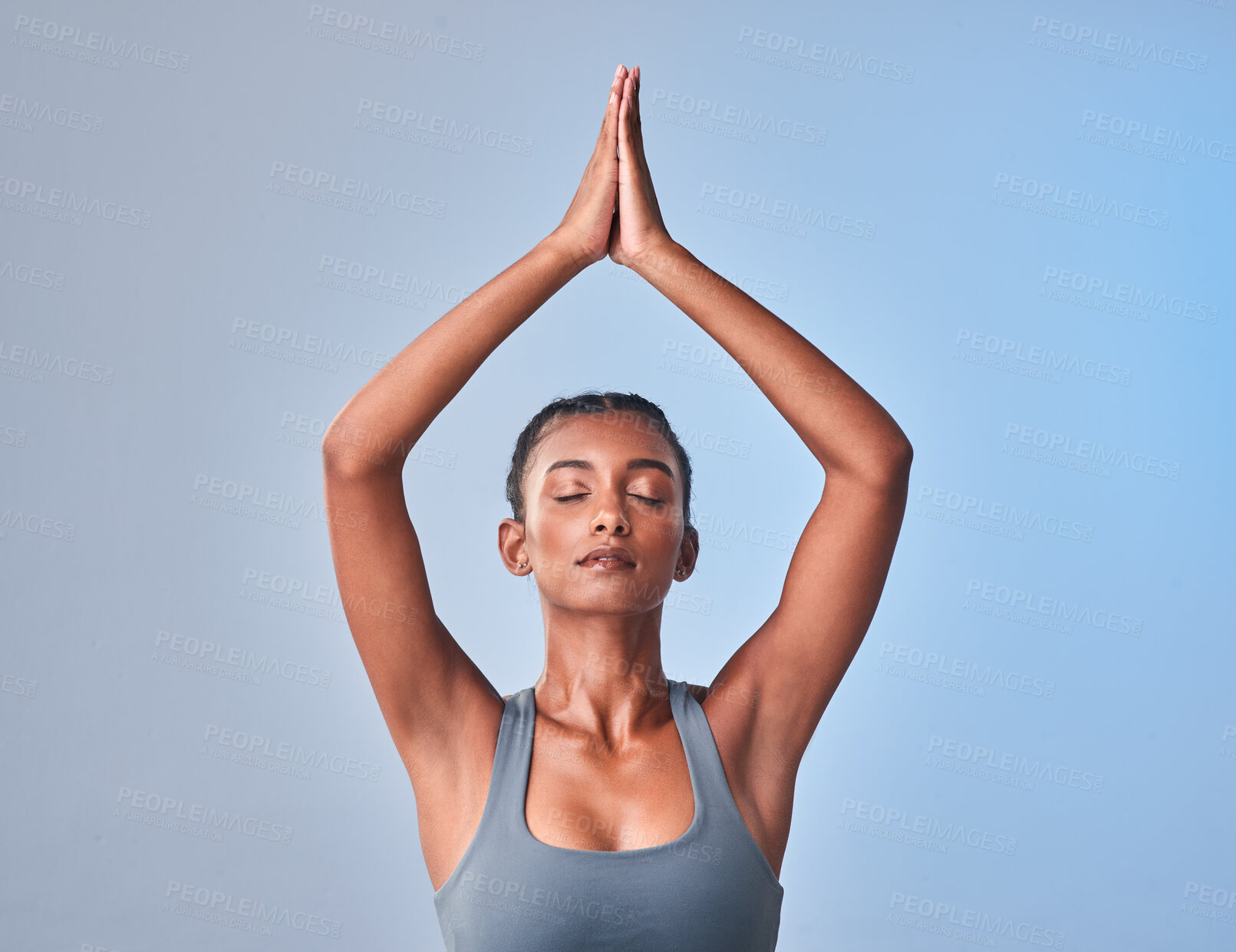 Buy stock photo Studio shot of a fit young woman meditating against a grey background