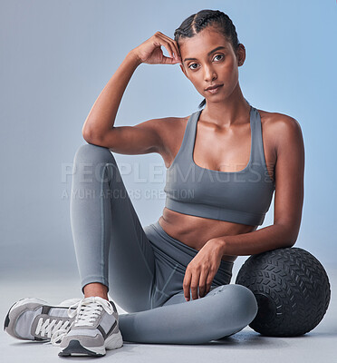 Buy stock photo Studio shot of a fit young woman working out against a grey background