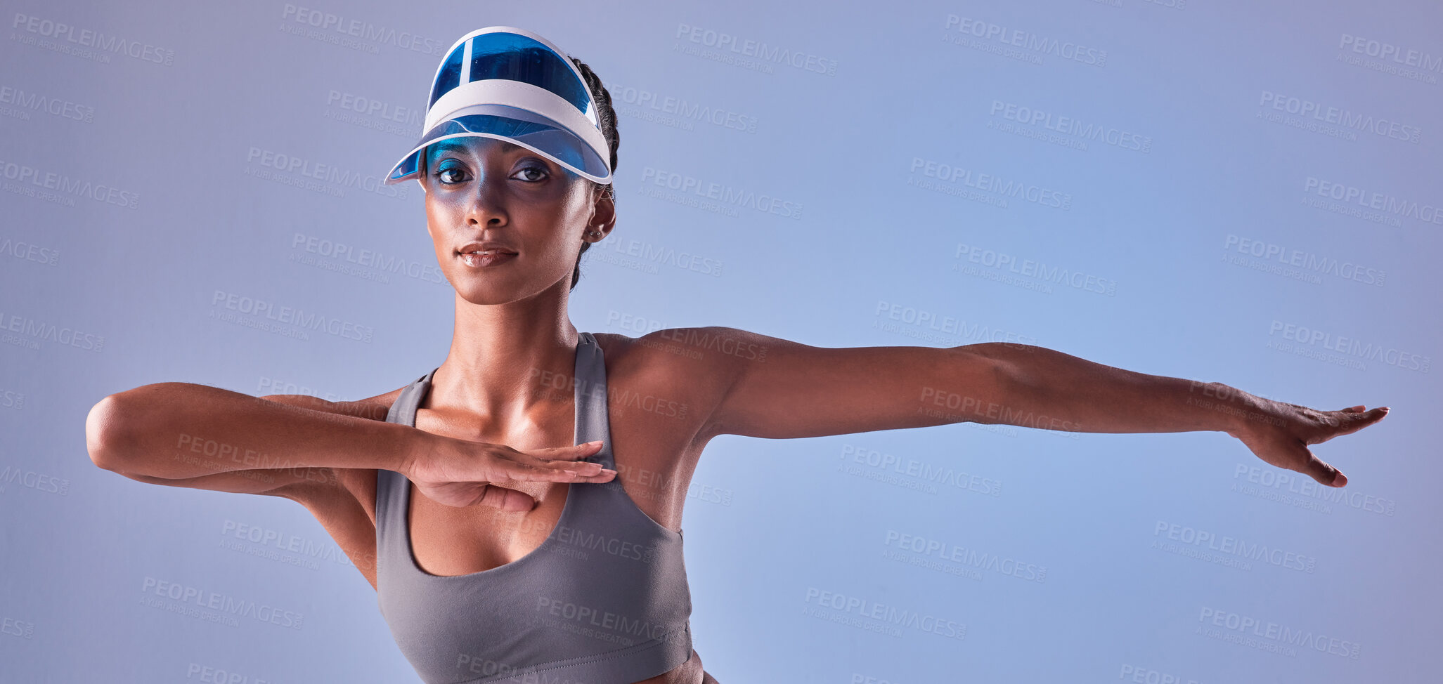 Buy stock photo Studio shot of a fit young woman stretching against a grey background