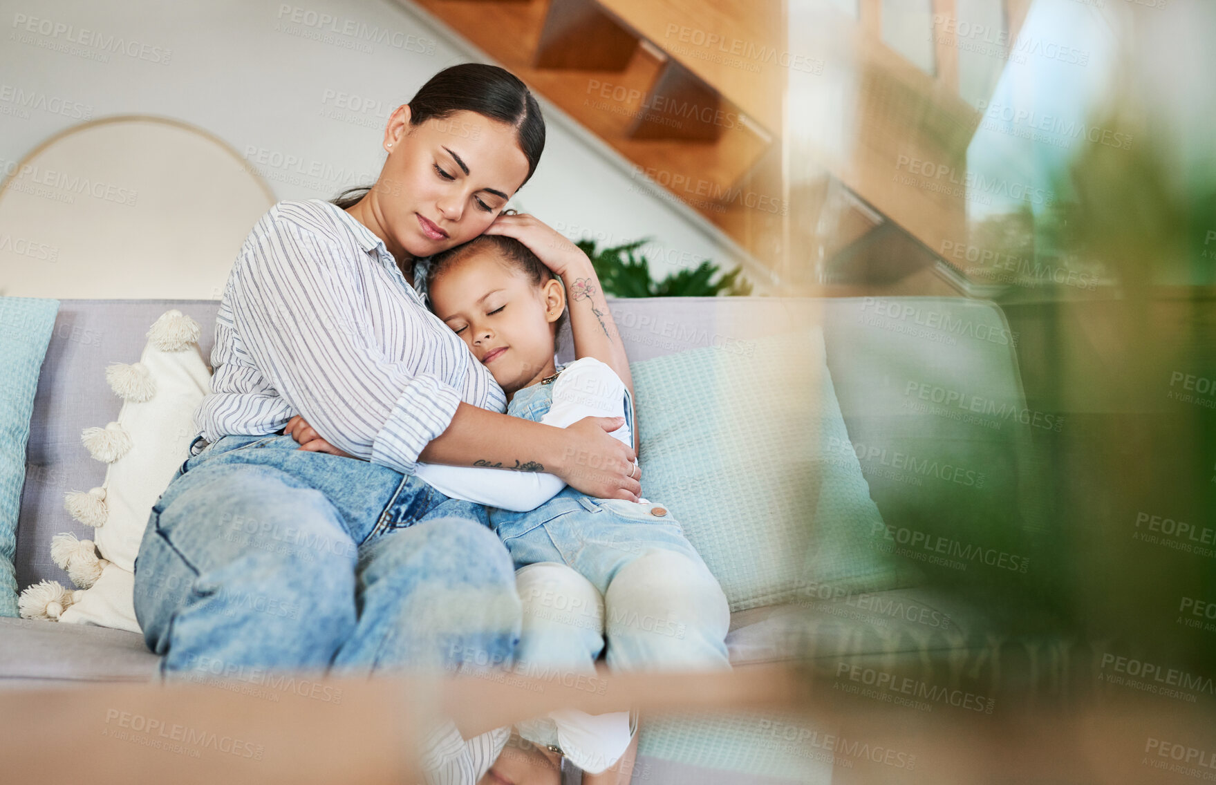 Buy stock photo Shot of a mother and her little daughter relaxing together at home