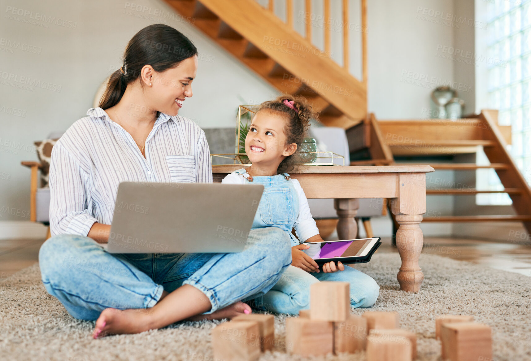 Buy stock photo Shot of a mother and her little daughter using digital devices at home