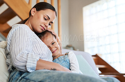 Buy stock photo Shot of a mother and her little daughter relaxing together at home