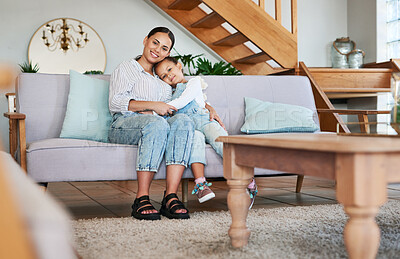 Buy stock photo Portrait of a mother and her little daughter relaxing together at home