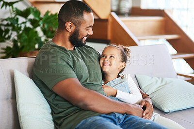 Buy stock photo Shot of a father and his little daughter relaxing together at home