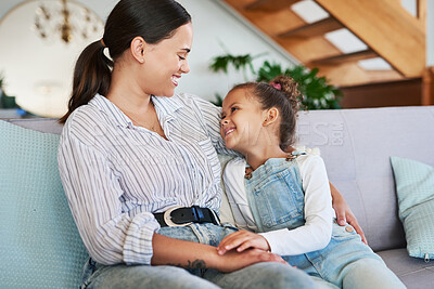 Buy stock photo Shot of a mother and her little daughter relaxing together at home
