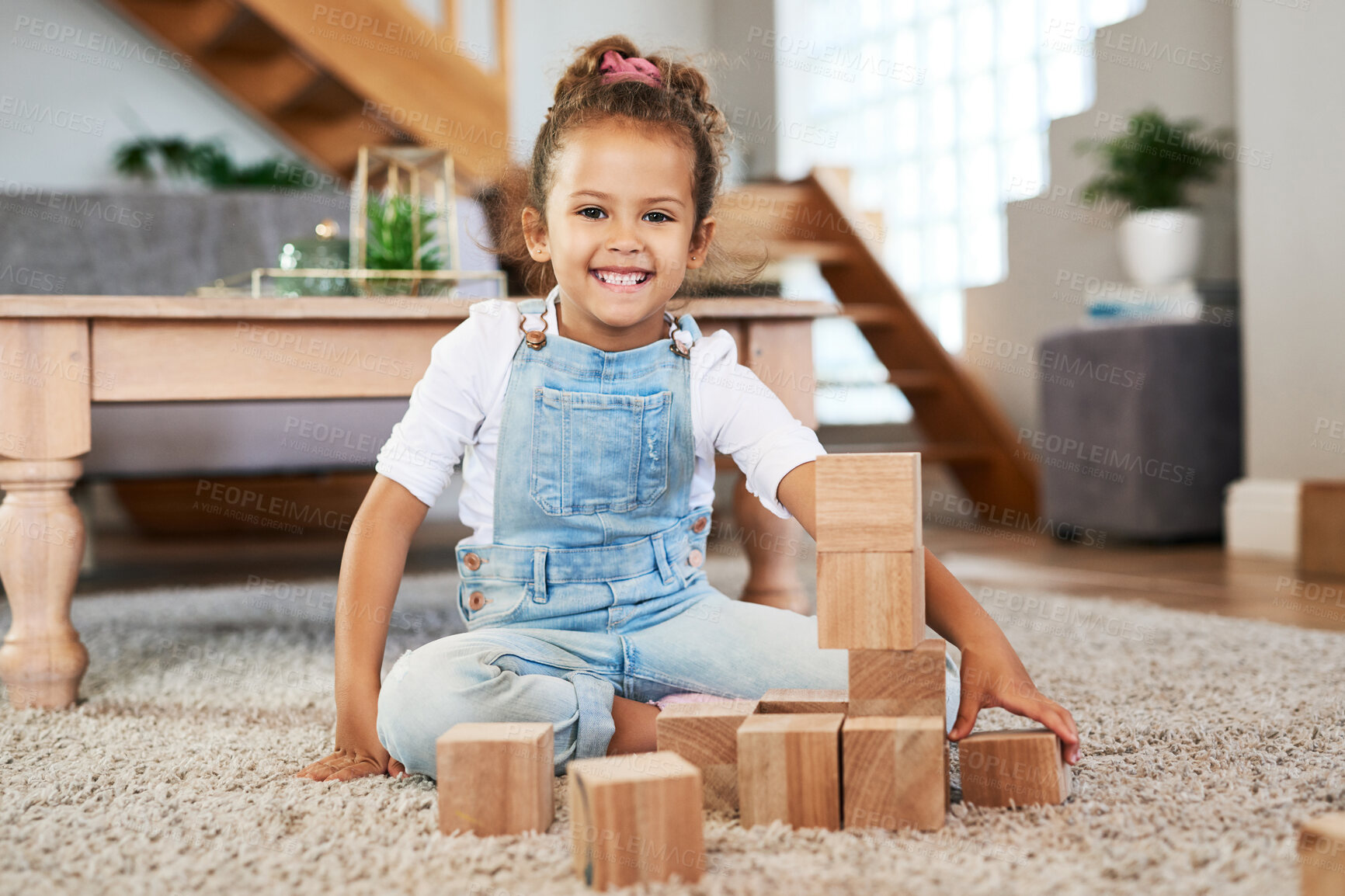 Buy stock photo Portrait of an adorable little girl playing with wooden blocks at home