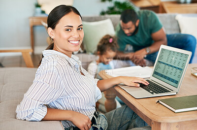 Buy stock photo Portrait of a mother using a laptop while her husband takes care of their little daughter at home