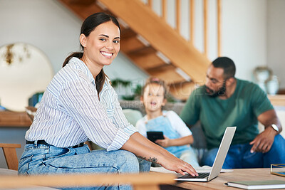 Buy stock photo Portrait of a mother using a laptop while her husband takes care of their little daughter at home