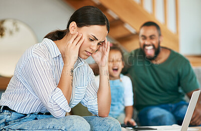 Buy stock photo Shot of a mother looking stressed out while her daughter and husband are screaming in the background at home