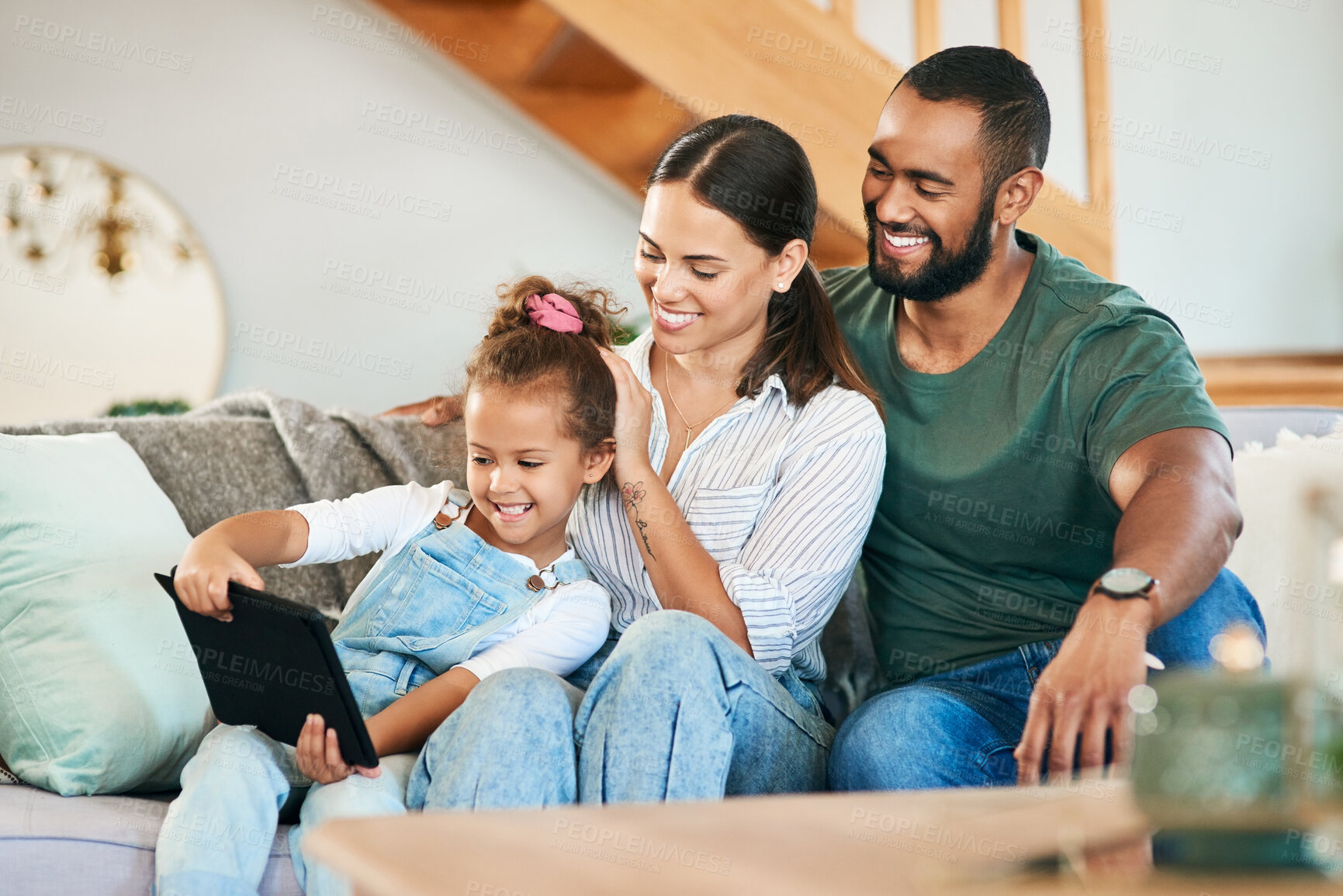 Buy stock photo Shot of a happy family using a digital tablet together at home