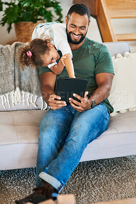 Buy stock photo Shot of a father and his little daughter using a digital tablet together at home