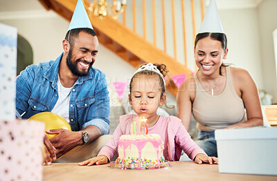 Buy stock photo Shot of a little girl celebrating a birthday with her parents at home