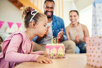 Buy stock photo Shot of a little girl celebrating a birthday with her parents at home