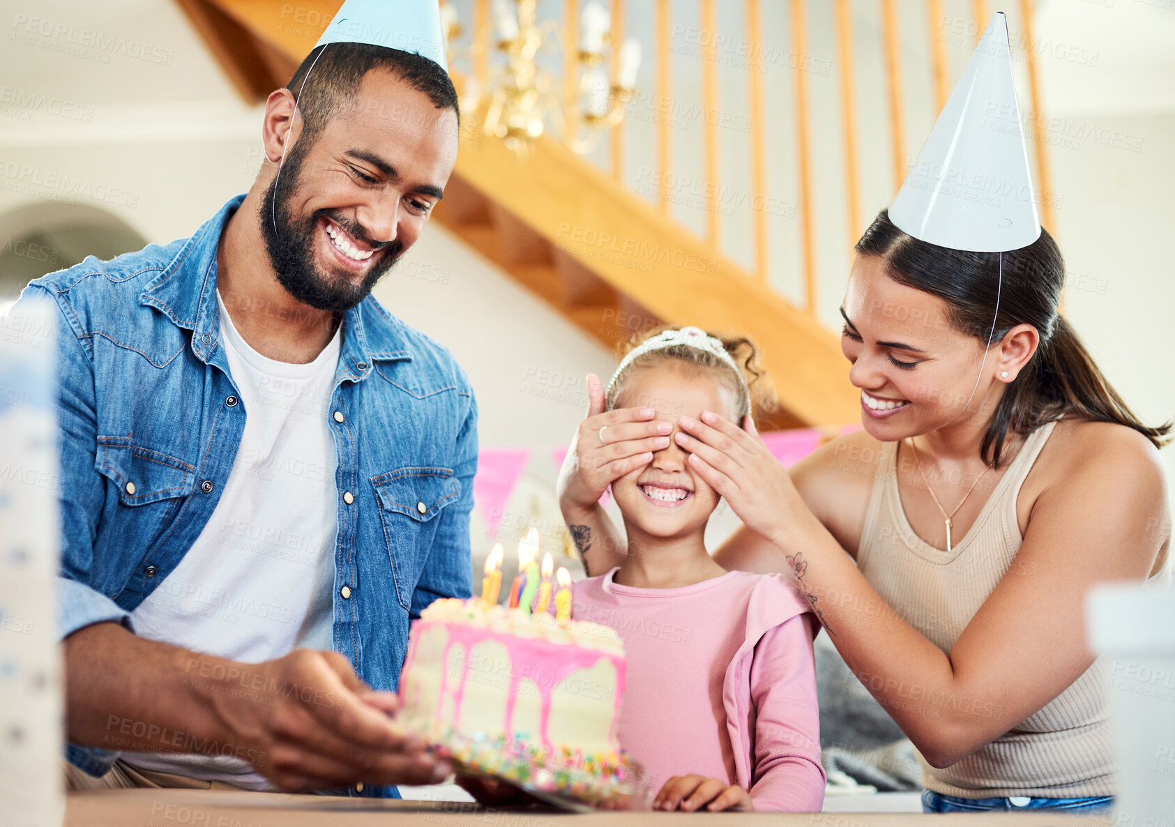 Buy stock photo Shot of a little girl celebrating a birthday with her parents at home