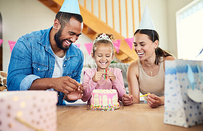 Buy stock photo Shot of a little girl celebrating a birthday with her parents at home