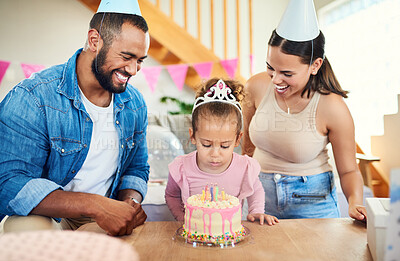 Buy stock photo Shot of a little girl celebrating a birthday with her parents at home