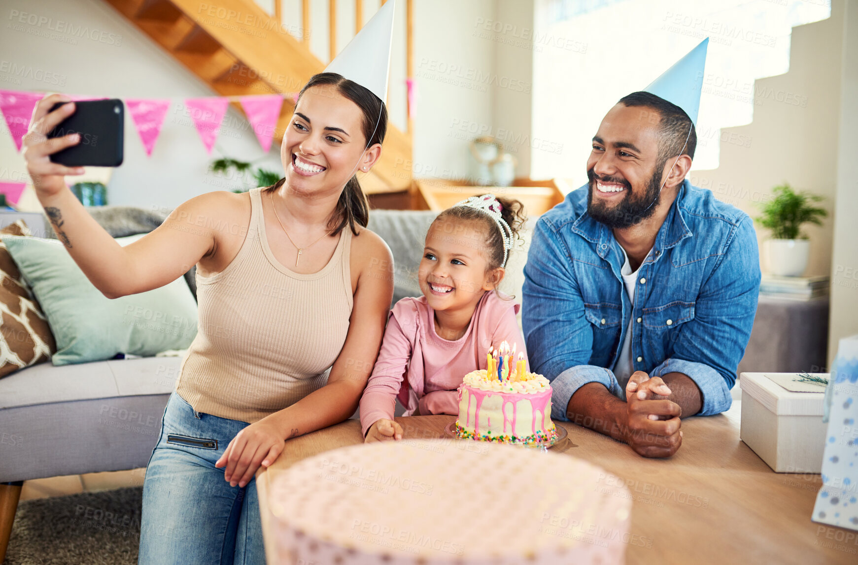 Buy stock photo Shot of a young mother taking a selfie at her daughter's birthday celebration at home