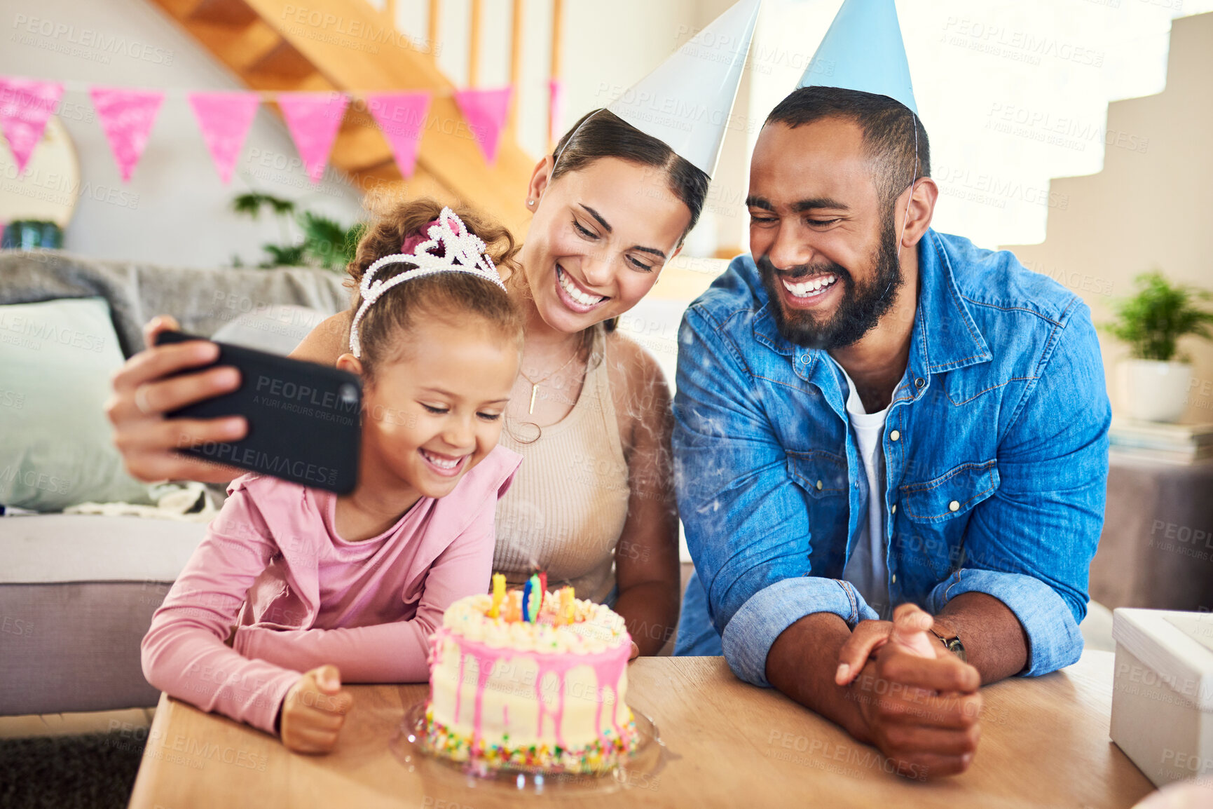 Buy stock photo Shot of a young mother taking a selfie at her daughter's birthday celebration at home