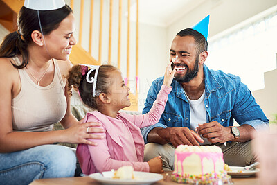 Buy stock photo Shot of a little girl celebrating a birthday with her parents at home