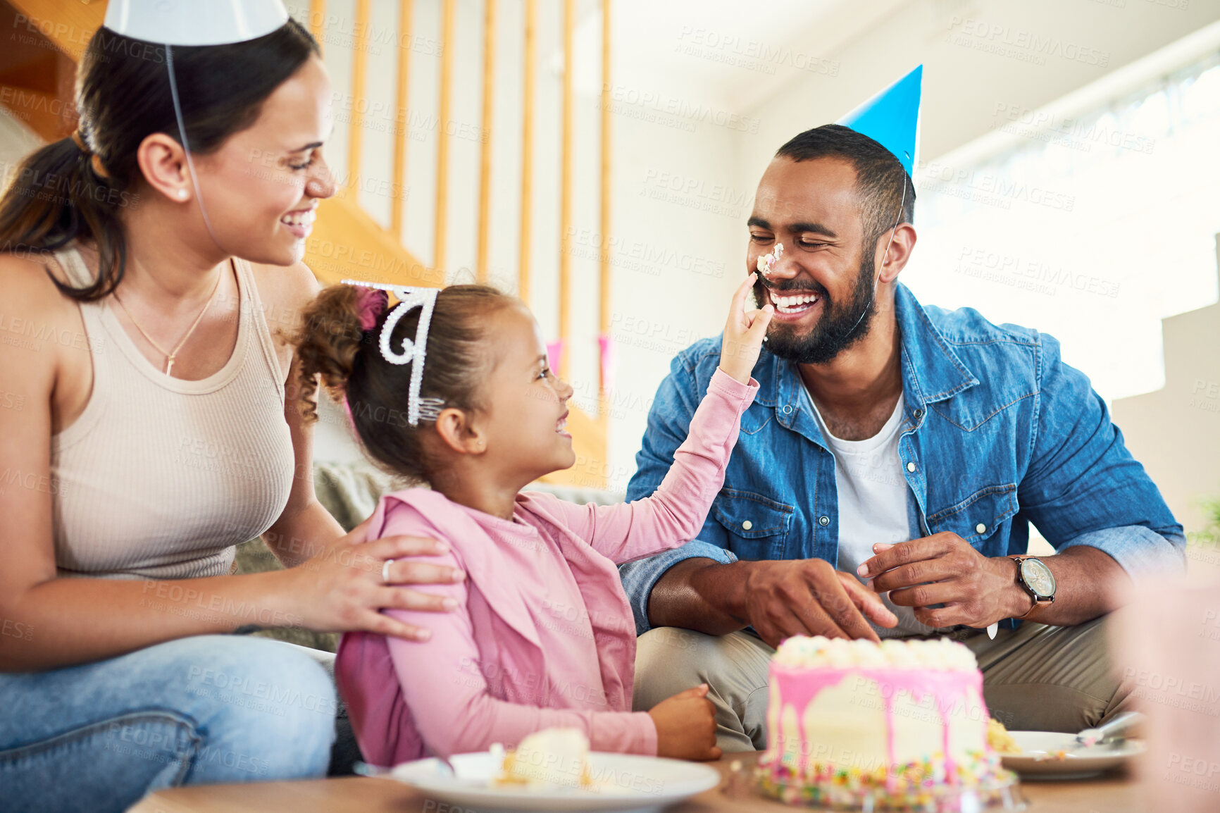 Buy stock photo Shot of a little girl celebrating a birthday with her parents at home