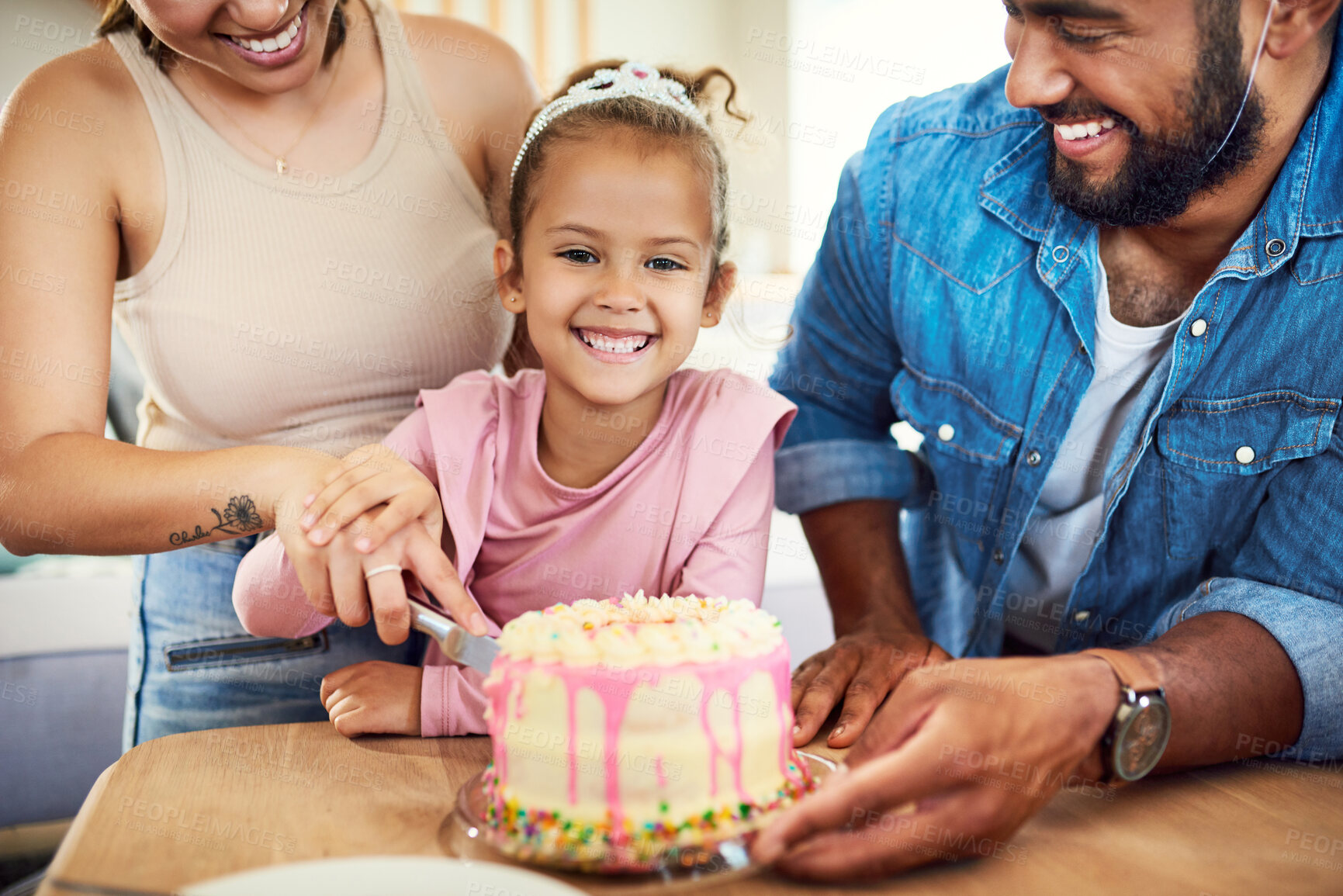 Buy stock photo Shot of a little girl celebrating a birthday with her parents at home