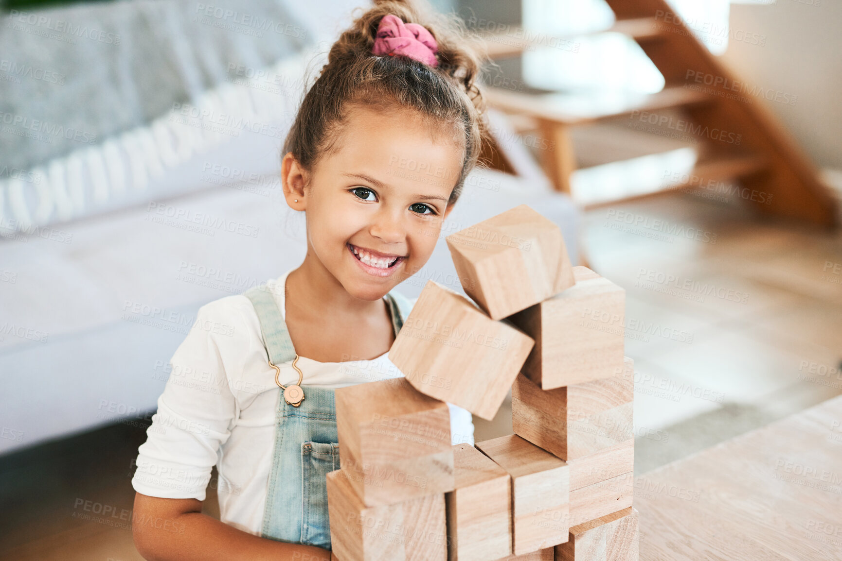 Buy stock photo Portrait of an adorable little girl playing with wooden blocks at home