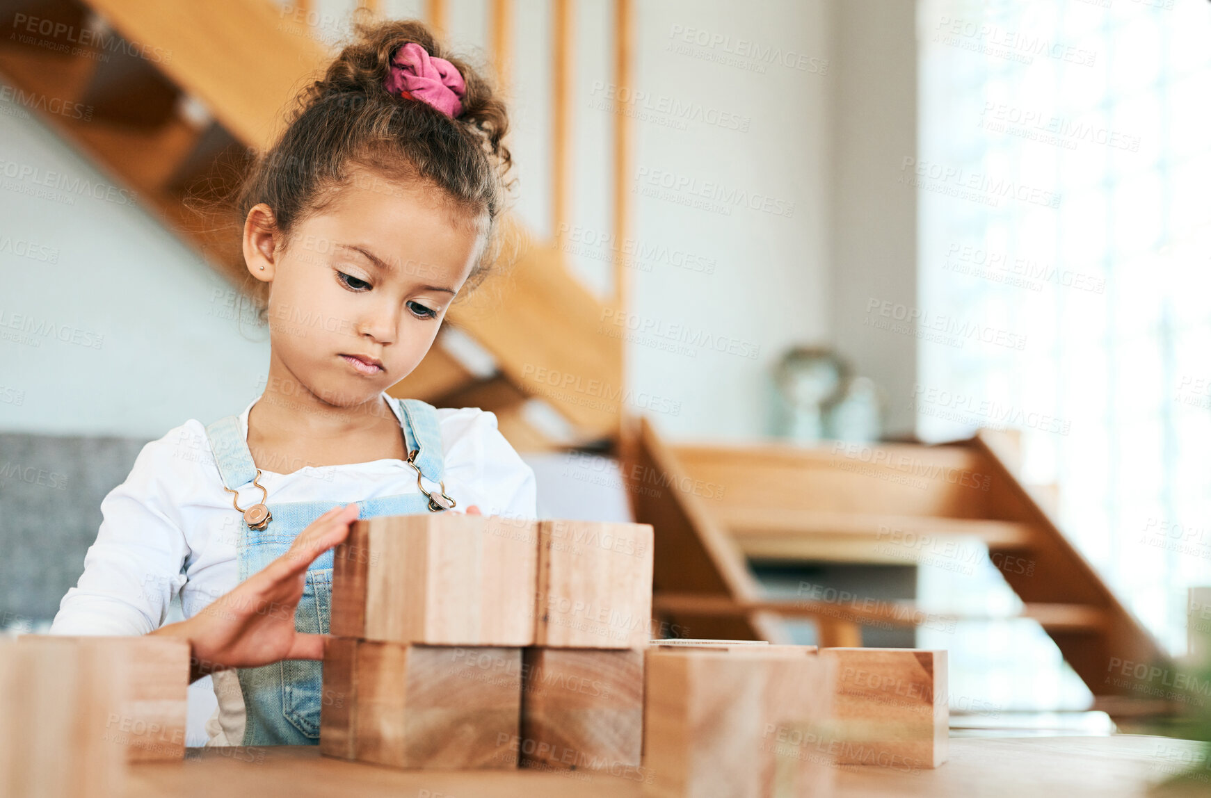 Buy stock photo Shot of an adorable little girl playing with wooden blocks at home