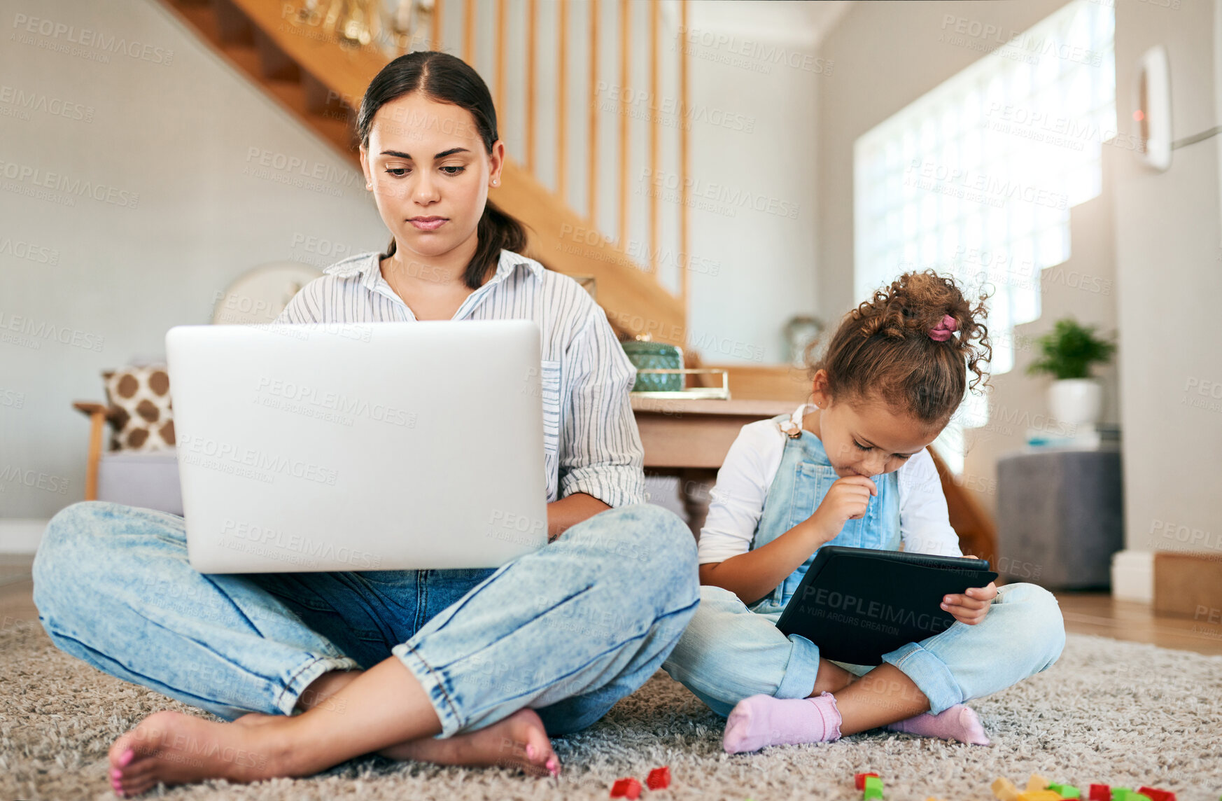 Buy stock photo Shot of a mother and her little daughter using digital devices at home