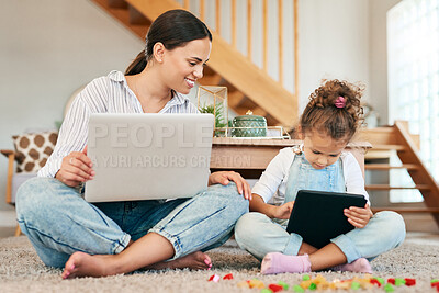 Buy stock photo Shot of a mother and her little daughter using digital devices at home