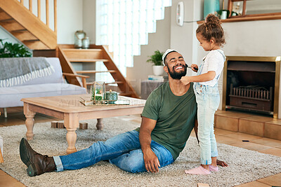 Buy stock photo Shot of a little girl putting makeup on her father while playing together at home