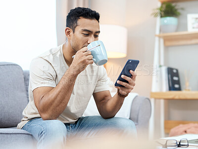Buy stock photo Man, phone and texting with coffee on sofa in home for taste of hot beverage. Asian person, reading and mobile app for finance, message or planning on internet and social media by cellular with drink