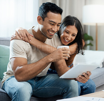 Buy stock photo Happy couple, embrace and tablet for social media on sofa in house for news, meme or post. Man, woman and laugh for funny joke with coffee for reading on internet, mobile app and web for relaxing